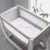 Shnuggle 100% Cotton 3-pack Air Crib Bedding Set in a cozy crib with soft grey and white patterns, featuring breathable mesh