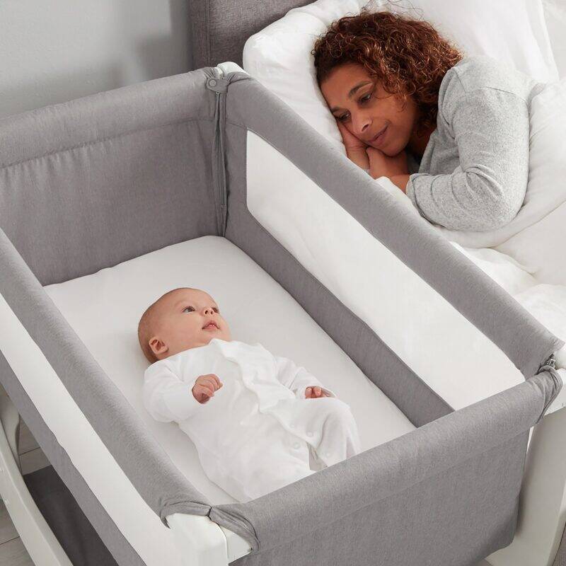 Shnuggle Air Bedside Crib in dove grey with a parent and baby peacefully sleeping side by side.