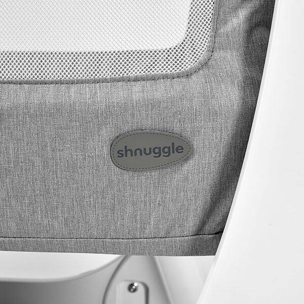 Shnuggle Air Bedside Crib in dove grey with a close-up of the branded logo detail on the side.