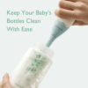 Momcozy Bottle Brush Kit in use, cleaning a baby bottle with a soft bristle head for effective hygiene.