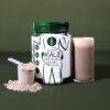 SoFitt™ Advanced Male Fertility Support in a jar with a scoop and a glass of mixed powder, set against a green background.