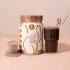 SoFitt™ Advanced Pregnancy Support powder in a jar next to a glass of chocolate smoothie with a straw.