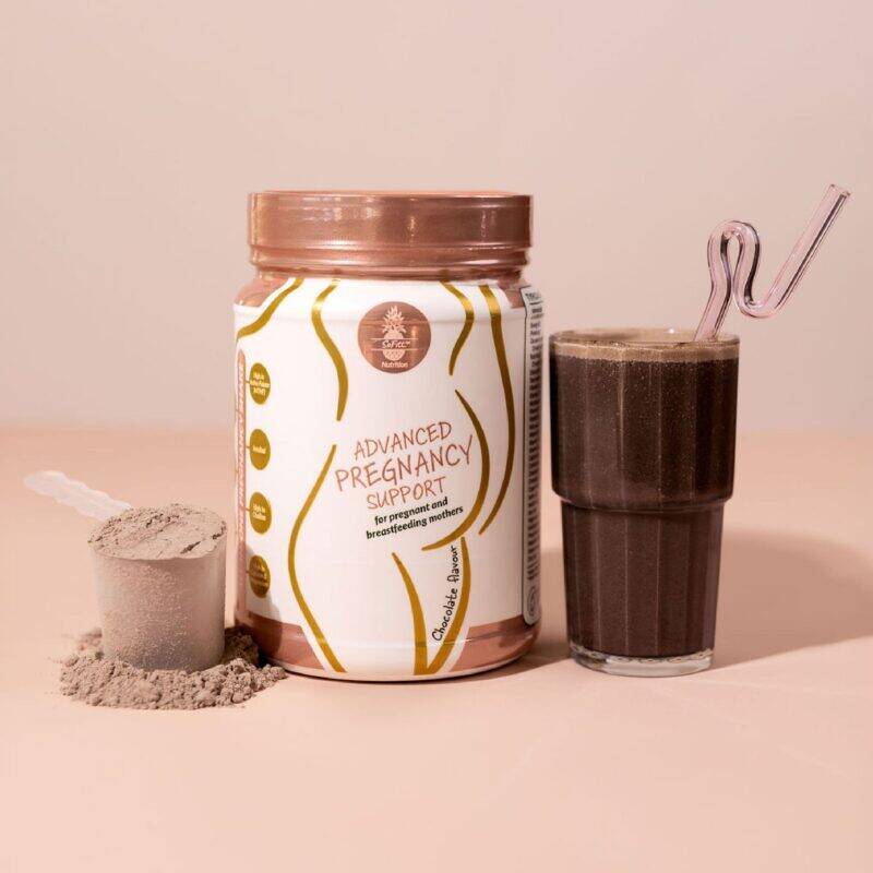 SoFitt™ Advanced Pregnancy Support powder in a jar next to a glass of chocolate smoothie with a straw.