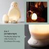 Tommee Tippee Penguin Night Light, soft white, features a portable design with an egg-shaped base for easy use.