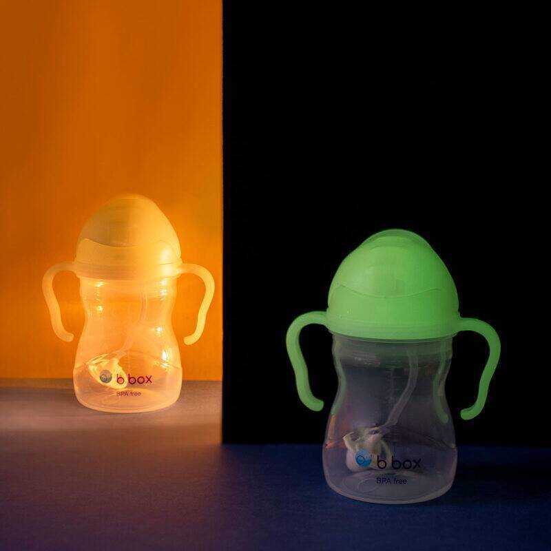 b.box Sippy Cup in Glow in the Dark, featuring ergonomic handles and a soft spout, illuminated against a dark background.