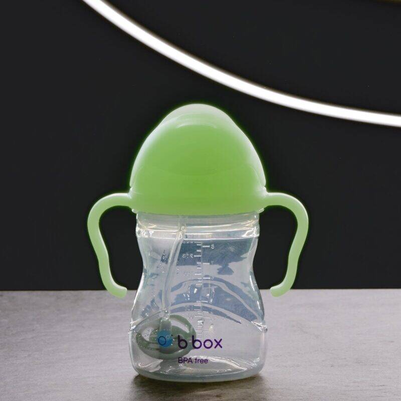 b.box Sippy Cup in Glow in the Dark with green lid and handles, featuring a clear body and straw for easy drinking.