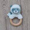 Back to Nature Wood Ring Rattle featuring a plush raccoon head in blue and pink with a natural wood ring.