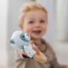 Back to Nature Wood Ring Rattle in blue and pink, featuring a soft animal design, held by a smiling toddler.